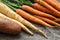Close up of a bundle of carrots, parsnip and sweet potato