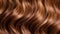 Close-up of a bundle of shiny natural brown curls of hair