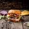 Close Up of Burger Piled High with Fresh Toppings on Whole Grain Artisan Bun, on Rustic Wooden Surface with Copy Space