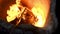 Close up of burning fire inside industrial furnace. Stock footage. View inside of a hot workshop at the metal smelting