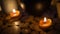 Close-up of burning tealight candle on table in home