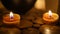 Close-up of burning tealight candle on table in home