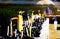 Close up of burning yellow candles in black clay pots with smoke on altar of Buddhist temple in Chiang Mai, Thailand