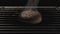 Close up of burnt bread inside the oven with metal bars on black background. Stock footage. Overbaked burger bun and