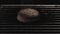 Close up of burnt bread inside the oven with metal bars on black background. Stock footage. Overbaked burger bun and