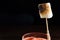 Close up burnt marshmallow that served with red cocktail with black background