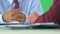 close-up of business hands holding pen on greenscreen