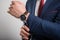 Close-up of business man wearing suit arranging jacket sleeve