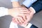 Close-up of business partners making pile of hands at meeting