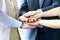 Close-up of business partners making pile of hands at meeting