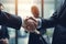 Close up of business people shaking hands in office. Handshake concept. Business people shaking hands, finishing up a meeting.