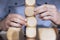 Close up of a business person arranging large wooden blocks. Business strategy and solutions