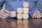 Close up of a business person arranging large wooden blocks. Business strategy and solutions