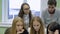 Close up of business team preparing the presentation of their startup. Two young fair-haired and one dark-haired girls