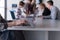 Close up of business womans hand typing on laptop with team on m