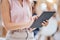 Close up of a business womans hands browsing on a digital tablet in an office. One female only using the internet online