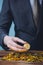 Close-up of businessman counting and holding bitcoin sign of coins - indicating cryptocurrency financial trade wealth and business