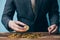 Close-up of businessman counting and holding bitcoin sign of coins - indicating cryptocurrency financial trade wealth and business