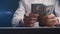 Close-up of a businessman counting money and beating his fist on the table. Cheating with payment.