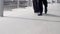 Close up businessman feet, pulling trolley bag at airport for work.