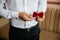 Close-up businessman groom holding bow-tie in his hands. Concept of men stylish elegance clothes