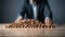 Close up of businessman hand placing wooden blocks on top of wooden table