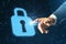 Close up of businessman hand pointing at abstract glowing padlock interface on blurry pattern background. Safety, firewall and