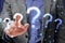Close up of businessman hand pointing at glowing polygonal question mark on blurry background. Ask, confusion and why concept.