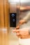 Close up of businessman hand pressing modern elevator button. Space for copy