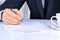 Close-up Of Businessman Hand Pressing a Stamp On Document in the office