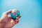 Close up of businessman hand showing a small model globe and blue sky