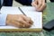 Close-up of a businessman hand signing a business contract book