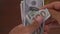 Close-up of a businessman hands counting hundred dollar bills