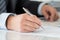 Close-up of businessman hands signing documents