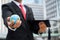 Close up Businessman holding Global Earth and Graduation cap in hand for education concept