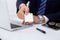 Close up of businessman or lawyer giving a business card while sitting at the table. He offering partnership and succe