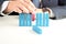 Close-up Of Businessman pushing out wooden block