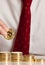 Close up businessman putting bitcoins on a pile