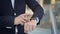 Close up of businessman s finger swiping to the left on smartwatch