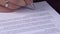 Close up of businessman`s hands signing business contract agreement at office desk - fake signature