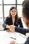 Close-up of a businessman shaking hands with a young Asian female job applicant who is happy