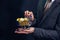 Close-up of businessman showing and holding push cart full of bitcoin sign of coin - cryptocurrency and future of digital finance