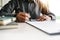 Close up businessman sign a contract, holding pen, sitting in office