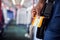 Close Up Of Businessman Standing In Train Commuting To Work Holding Ticket