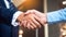 Close up businessmen shaking hands during a meeting. Handshake deal business corporate