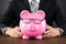 Close-up Of Businessperson Holding Piggybank