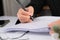 Close up of businesswoman hands writing at business document at workplace