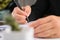 Close up of businesswoman hands writing at business document at workplace