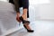 Close Up Of Businesswoman At Home Sitting On Bed Putting On Shoes Before Leaving For Work