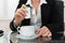 Close-up Of Businesswoman Putting Sugar In Cup